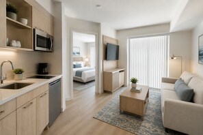 Een modern appartement met keuken, woonruimte, slaapkamer en badkamer.