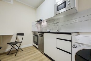 A compact kitchen with a microwave, oven, and dishwasher. - Two-bedroom apartment in downtown Barcelona 2-2 (Barcelona)