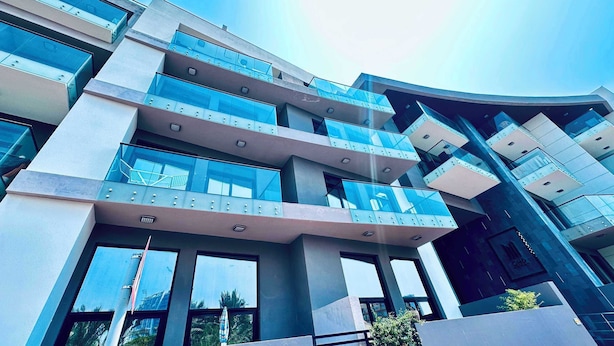 A multi-story building with balconies, large windows, and a modern architectural design. - Premium Holiday Apartment at La Perla  (Dubai)