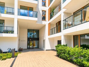 A modern multi-story building with glass balconies and a central entrance. - Chmielna Duo Royal | Warsaw Center & Parking (Warszawa)