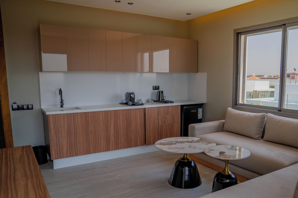 A modern kitchen with wooden cabinets, a built-in sink, and a compact dishwasher.