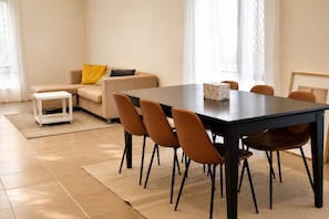 A modern living room with a dining table, sofa, and chairs. - Private 3-Bedroom Upper-Level Apartment, Self Check-in (Collingwood Park)