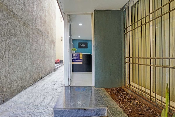 A hallway with a reception desk, a 'No Smoking' sign, and a 'Collection' sign.
