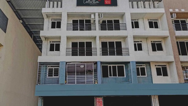 A multi-story building with a sign for 'Collection' and 'Hotel Bhumi World' indicating a hotel and possibly a collection or showroom. - Classic Bhumi Stay inn (Bhiwandi)
