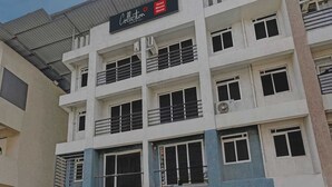 A multi-story hotel building with balconies, air conditioning units, and a sign indicating it is the Hotel Bhumi World. - Classic Bhumi Stay inn (Bhiwandi)