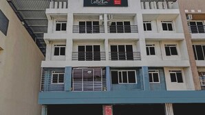 A multi-story building with a sign for 'Collection' and 'Hotel Bhumi World' indicating a hotel and possibly a collection or showroom. - Deluxe Bhumi Stay inn (Bhiwandi)