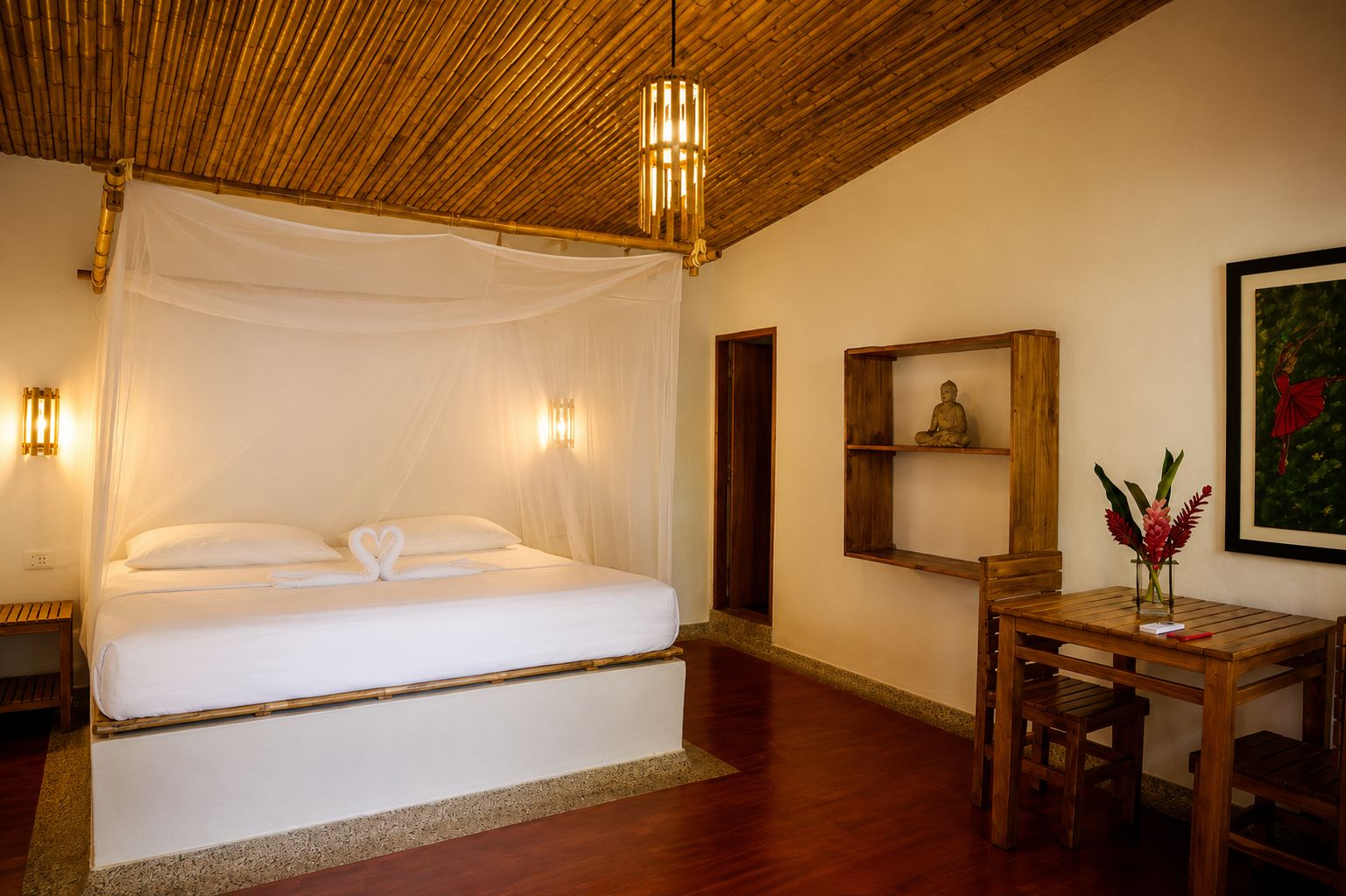 A room with a bed, bedside table, and a wall-mounted shelf with a statue.