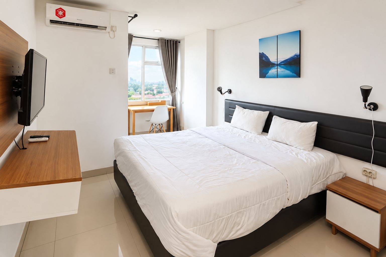 A modern hotel room with a large bed, a desk with a chair, a flat-screen TV, and a painting on the wall.