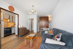 Un appartement moderne comprenant une cuisine, un coin repas et un salon.