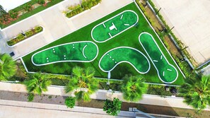 An aerial view of a golf course with multiple green areas and pathways. - Indigo, Modern Apt Steps from Playa Brujas Beach (Mazatlán)