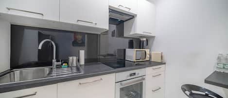 A modern kitchen with stainless steel appliances, a microwave, and a built-in oven.