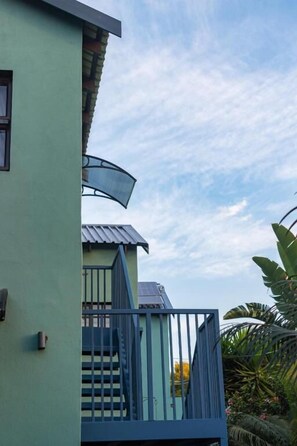 A building with a balcony, a staircase, and a view of the sky. - Falcons Rest  (Pretoria)