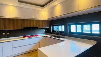 Uma cozinha moderna com ilha central, armários embutidos e janela que proporciona luz natural.