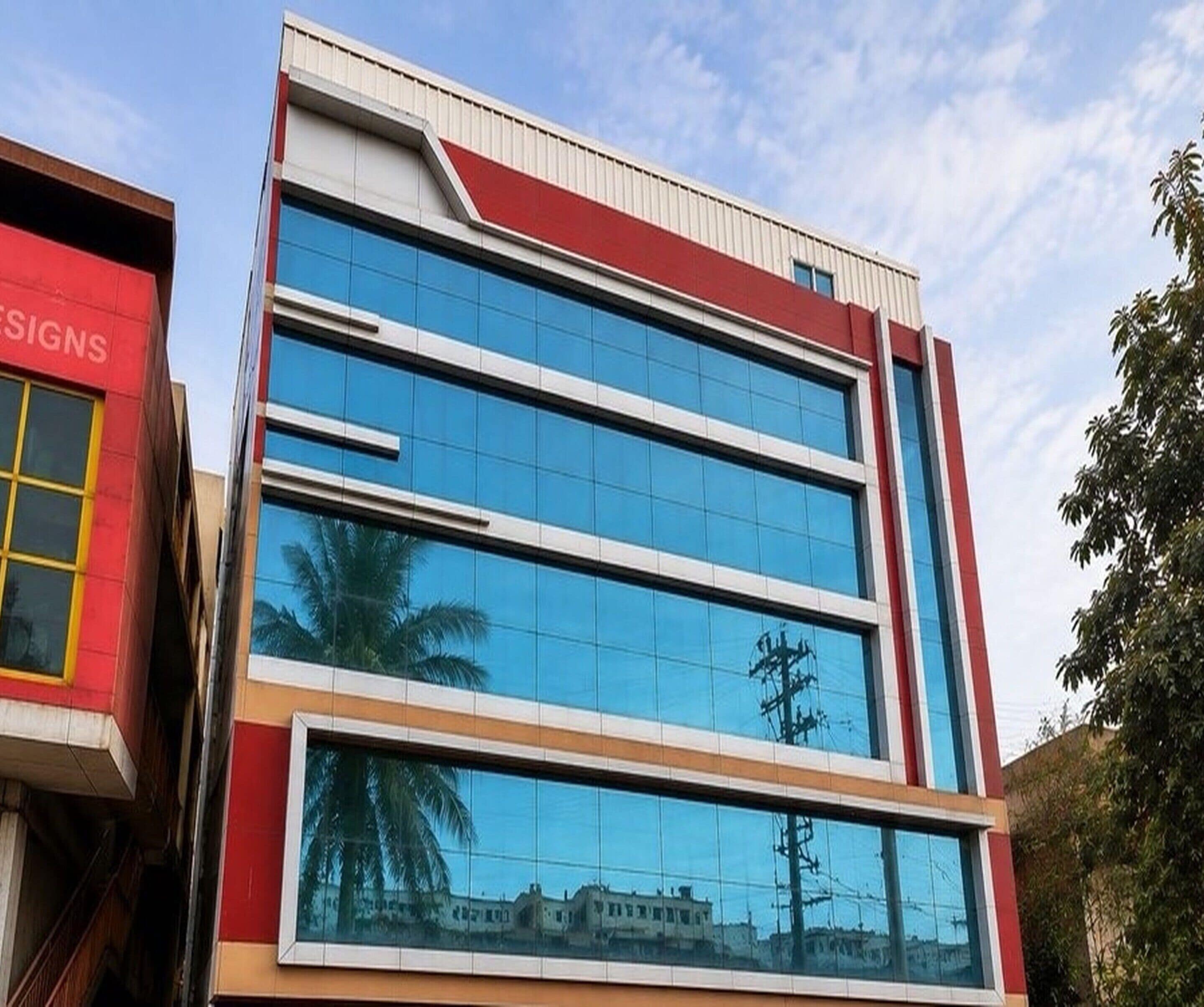 A modern building with a glass facade and a red and white color scheme.