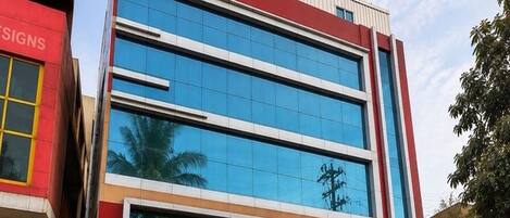 A modern building with a glass facade and a red and white color scheme.