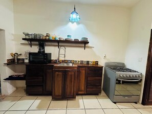 A kitchen with a stove, sink, and various appliances.
