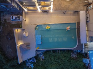 An aerial view of a hotel with a swimming pool, outdoor seating, and a covered area with a sign. - Shanti Verdant Resort Yangshuo (Guilin)