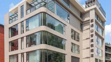 A multi-story hotel with a modern architectural design, featuring large windows and a flat roof.