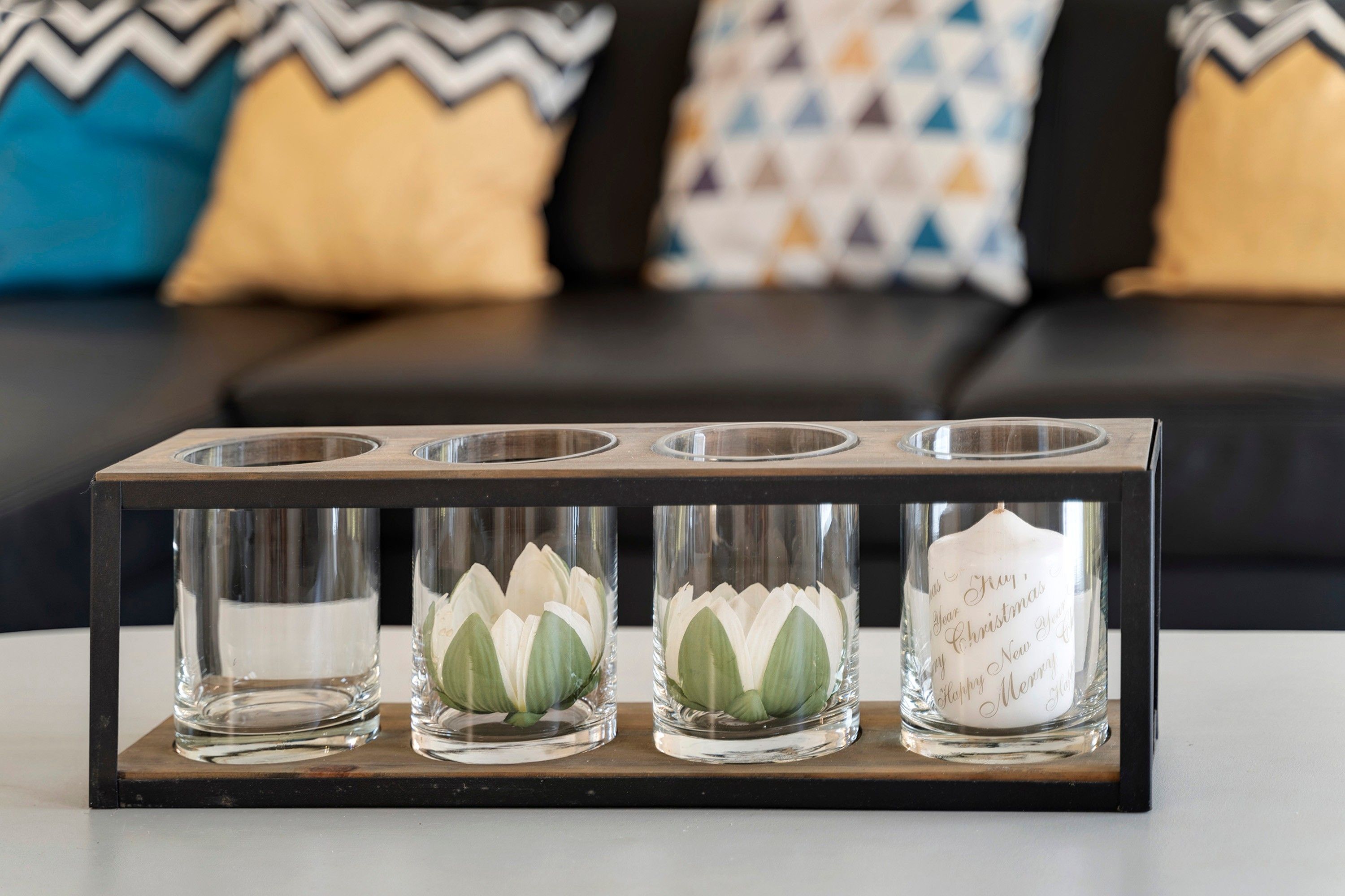 A candle holder with four candles on a table.