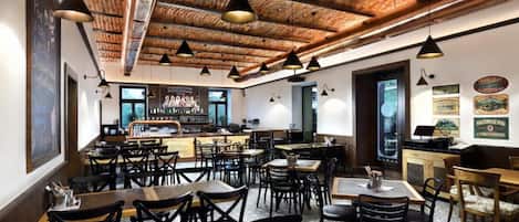 A restaurant with a brick ceiling, multiple tables, and chairs.