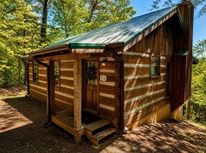 A rustic cabin with a porch, a door, and a window. - Mtn Views + Hot Tub | 10 Min to Pigeon Forge (Sevierville)