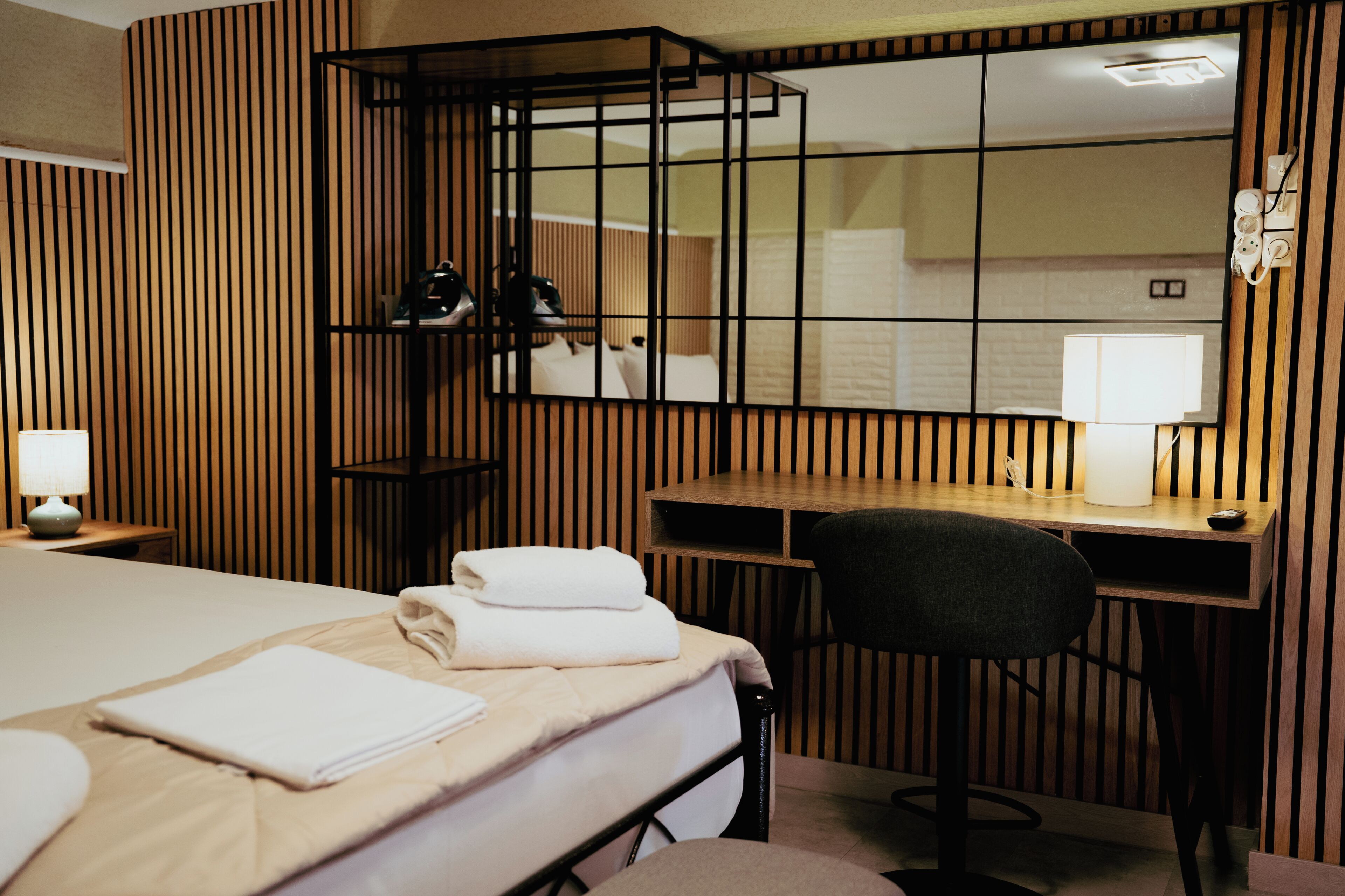 Une chambre d’hôtel avec un lit, un bureau et une chaise.