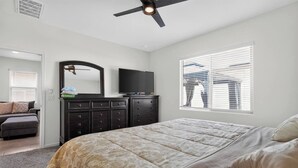 A bedroom with a bed, dresser, television, and a window with blinds. - Mins to Banner* St. Mary’s* El Rio* TUS Airport (Tucson)