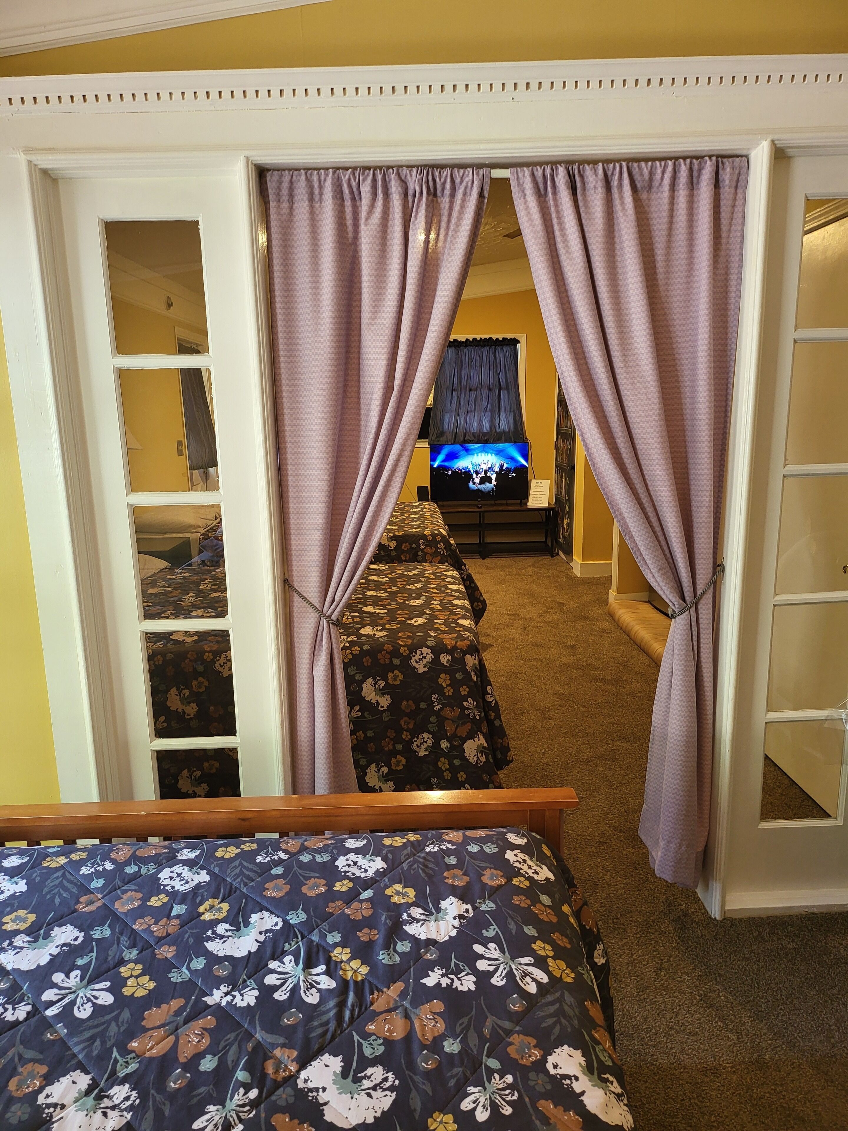 A bedroom with a bed, a TV, and a wardrobe.