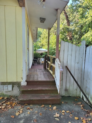 A wooden staircase leading to a porch with a white fence and a table with chairs. - IN-LAW SUITE/STUDIO 5 minutes to Stone Mountain Park (Stone Mountain)