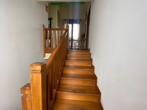 A wooden staircase with a handrail leading to a landing. - House with Garden Steps from Cantabria’s Main Beaches (Arguedes)
