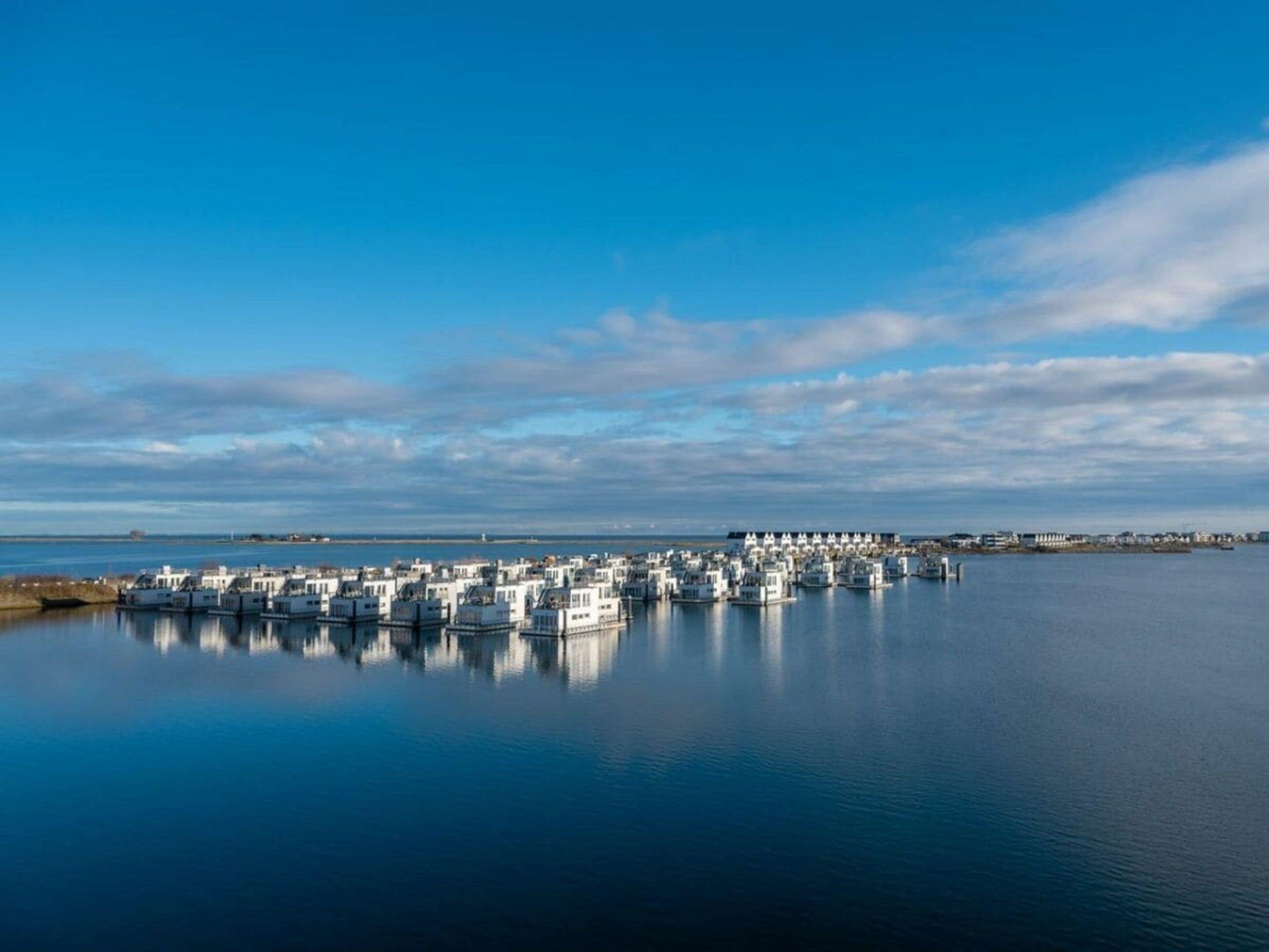 A marina with numerous docked boats and a clear sky.