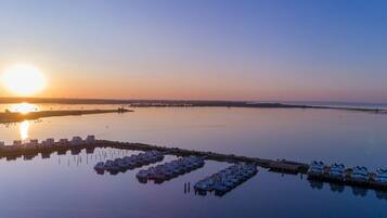 A marina with docked boats and a row of houses.