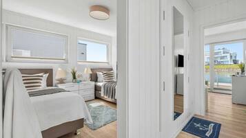 A modern bedroom with a bed, bedside tables, and a view of the outside.