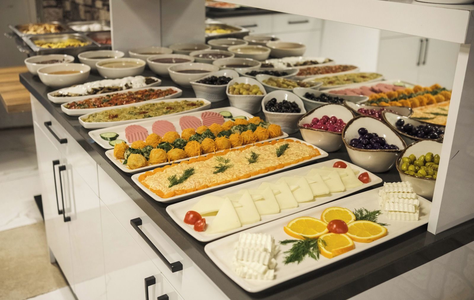 A buffet with various food items and condiments.