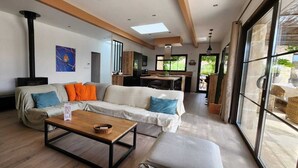 A modern living room with a sofa, a coffee table, and a fireplace.