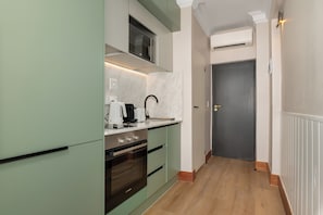 A modern kitchen with a built-in oven, a microwave, and a coffee maker. - Charlie and the Chairman | Urban Retreat (Cape Town)