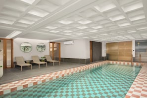 A swimming pool with checkered tiles, lounge chairs, and a ceiling with a grid pattern. - Charlie and the Chairman | City Views and Style (Cape Town)