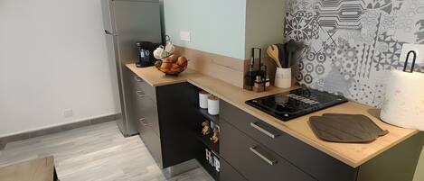 A modern kitchen with a built-in stove, a microwave, and a large island with a sink.