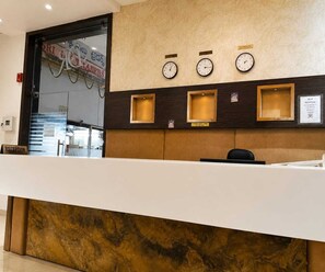 A reception desk with clocks, a reception sign, and a sign indicating Wi-Fi reception. - Deluxe Room Hotel Stay Comfort (Hyderabad)