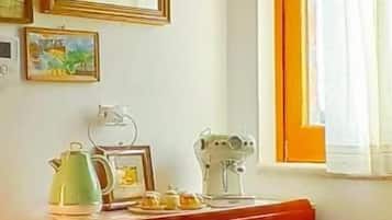 A room with a wooden cabinet, a sewing machine, and framed pictures on the wall.