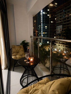 A balcony with a table, chairs, and a bottle of wine. - "Beautiful luxurious spacious 2 bedroom 
apartment with amazing amenities..." (Nairobi)