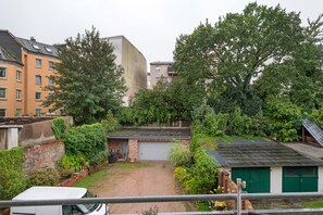 A residential area with a garage, a small shed, and a parked vehicle.