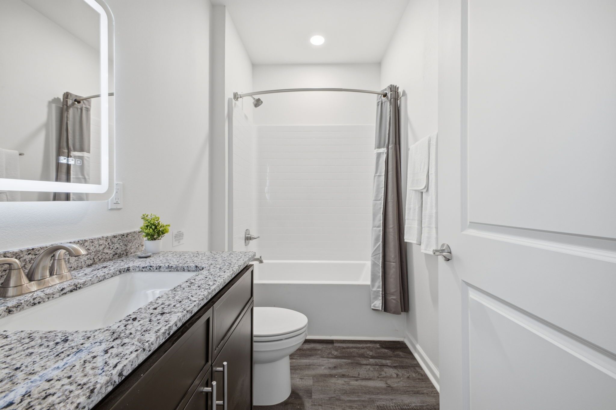 Une salle de bain avec douche, toilettes et lavabo.