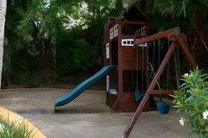 A playground with a slide and swings. - 3 BR · 2 Pools · Jungle Club · Beach Club (La Cruz de Huanacaxtle)