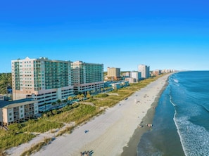 A coastal hotel with multiple buildings, a sandy beach, and the ocean. - Oceanfront 2BR Crescent Keyes 1103- I/O Pools (North Myrtle Beach)