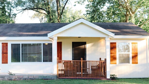 A single-story house with a front porch, a door, and a window with shutters. - Hearth & Willow Cottage Steps from Downtown (De Soto)