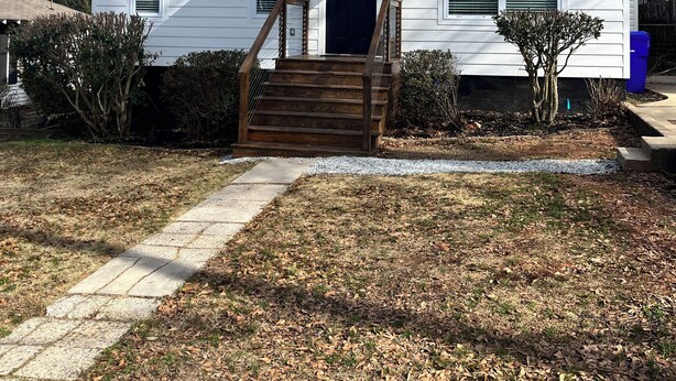 A single-story house with a front porch, a dark blue door, and a small tree in the yard. - Modern Magnolia on McAdoo bungalow near Cleveland Park/Downtown GVL 3 bdrm/2 ba (Greenville)