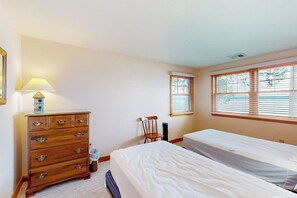 A bedroom with a single bed, a wooden dresser, a chair, and a window with blinds. - 5BR Lakefront Dog Friendly - Dock - Deck - Washer Dryer (Alton)