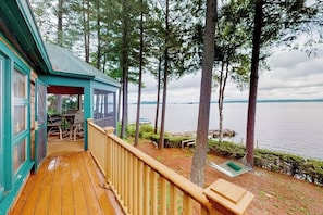 A wooden deck with a view of a lake, a covered seating area, and a hammock. - 5BR Lakefront Dog Friendly - Dock - Deck - Washer Dryer (Alton)