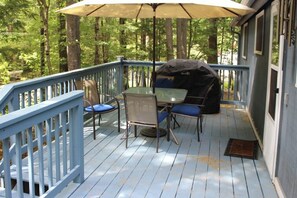An outdoor deck with a table and chairs, a grill, and a blue railing. - 3BR Near the Beach - Deck - Tennis - Washer Dryer (Moultonborough)